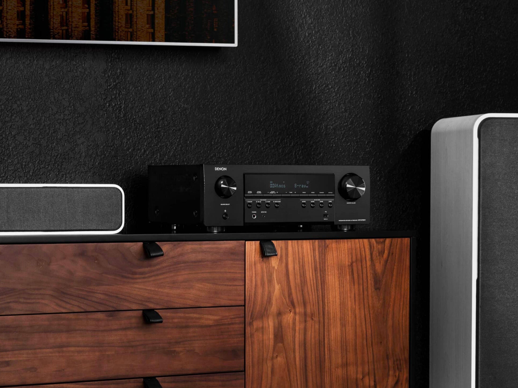 Audio equipment on a wooden cabinet with a dark wall background
