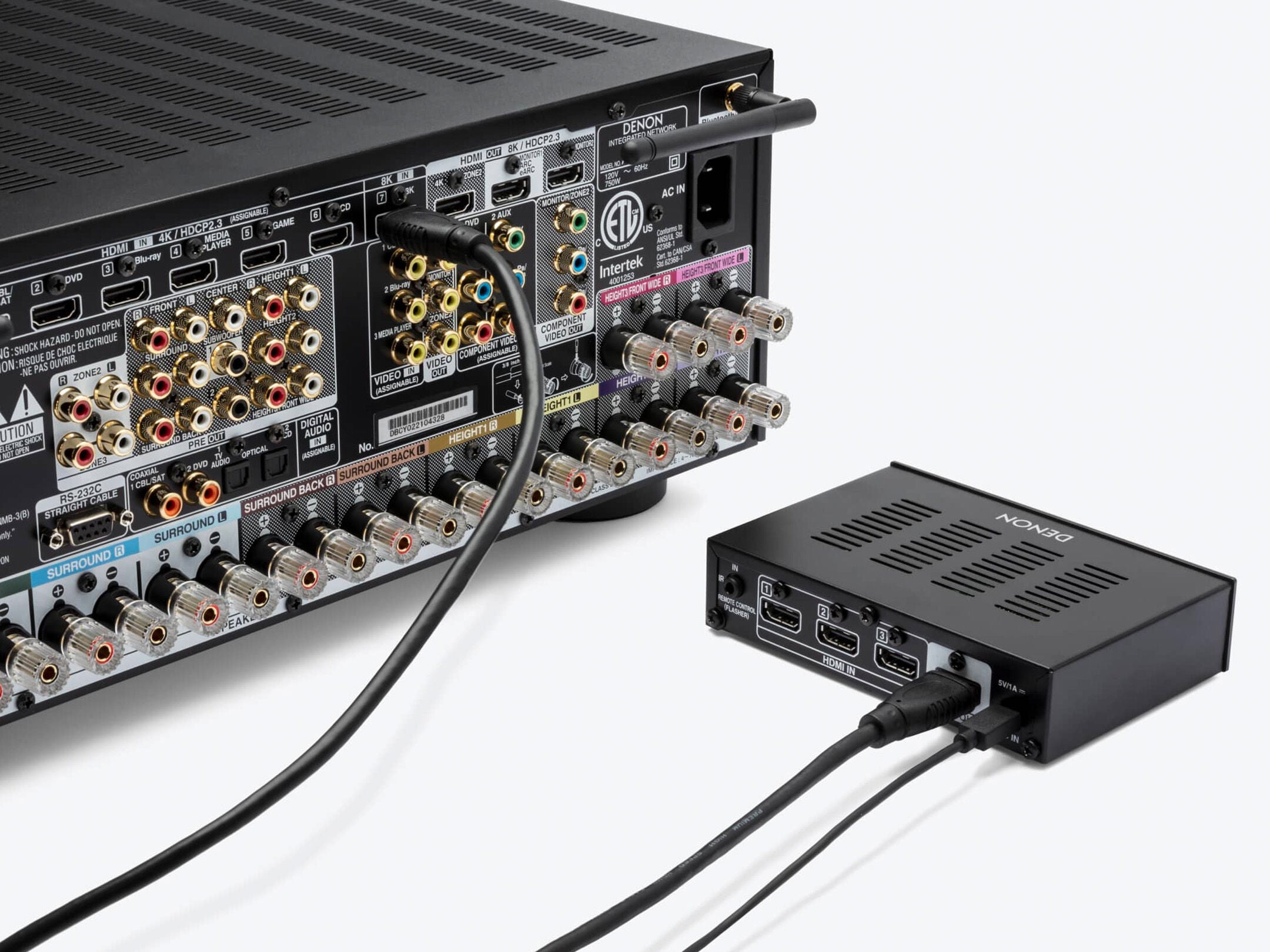 Denon receiver with A/V switcher on a white background