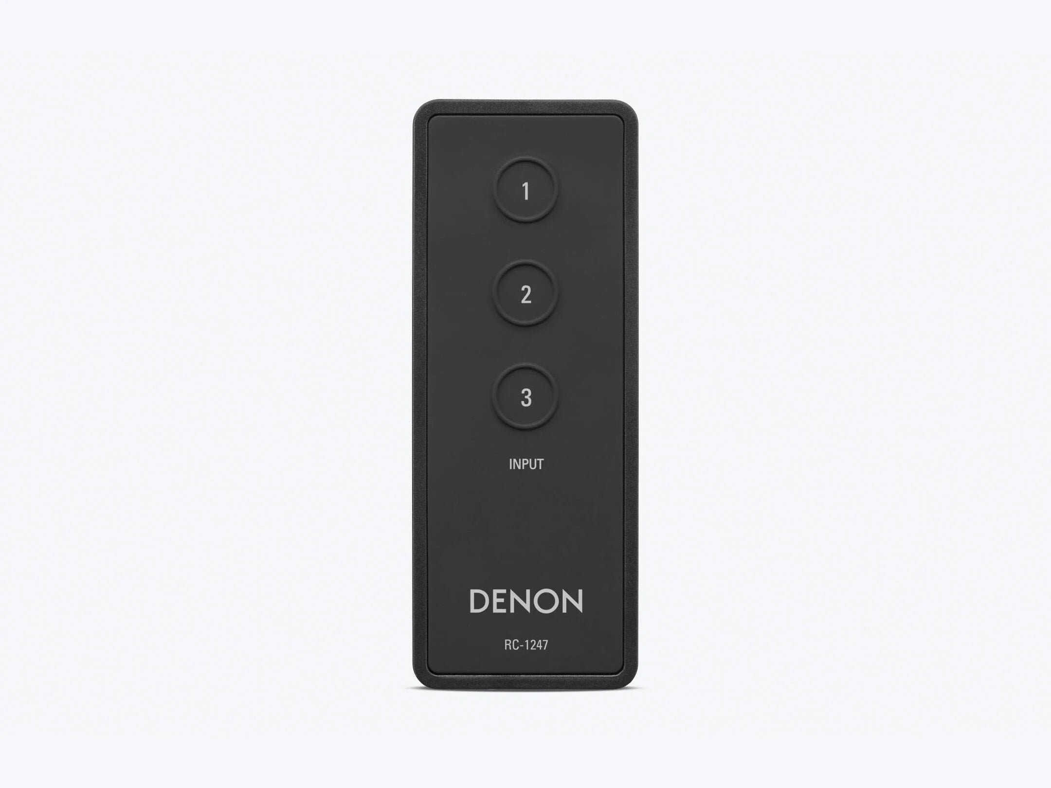 Black Denon remote control on a white background