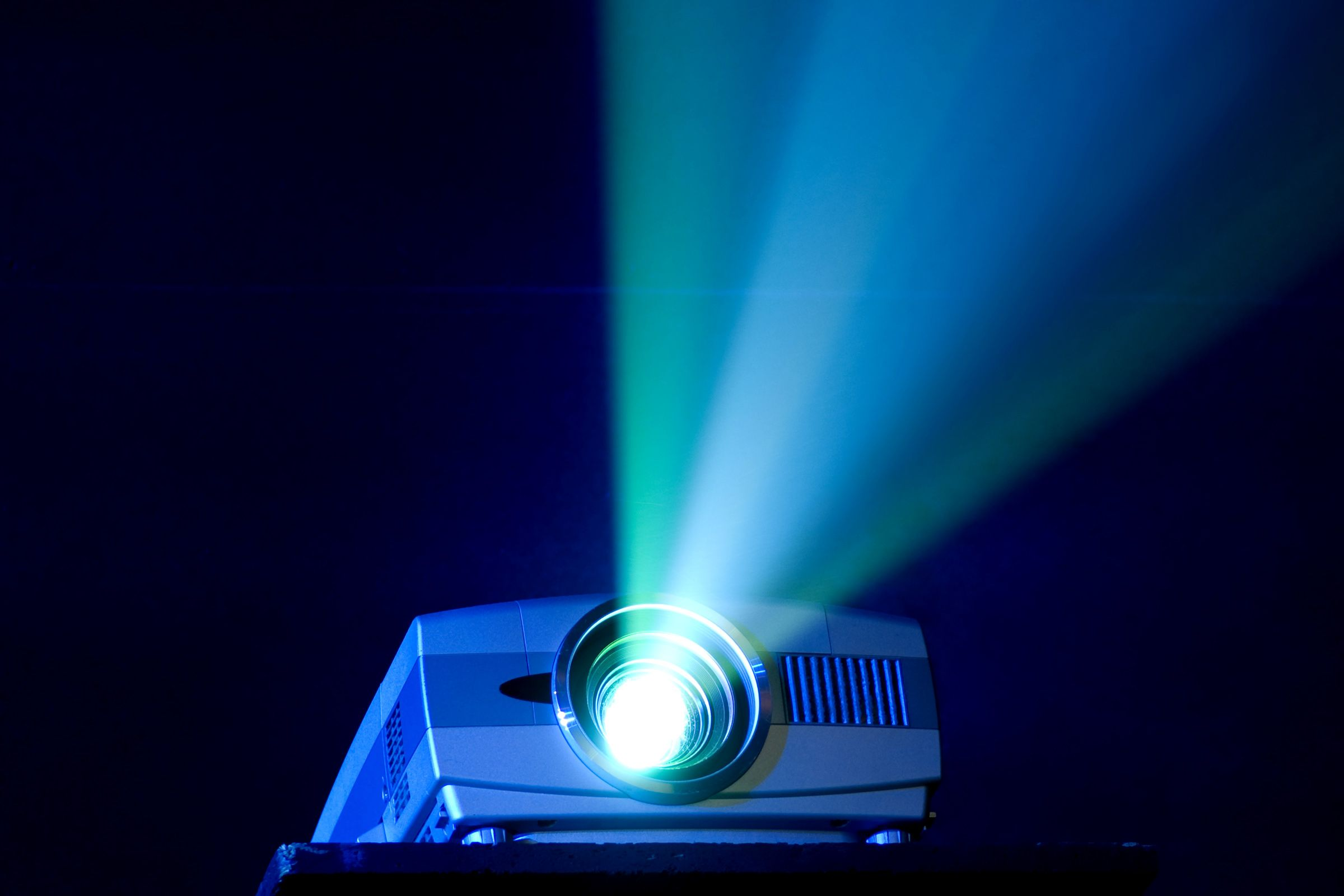 Projector emitting a beam of light on a dark background