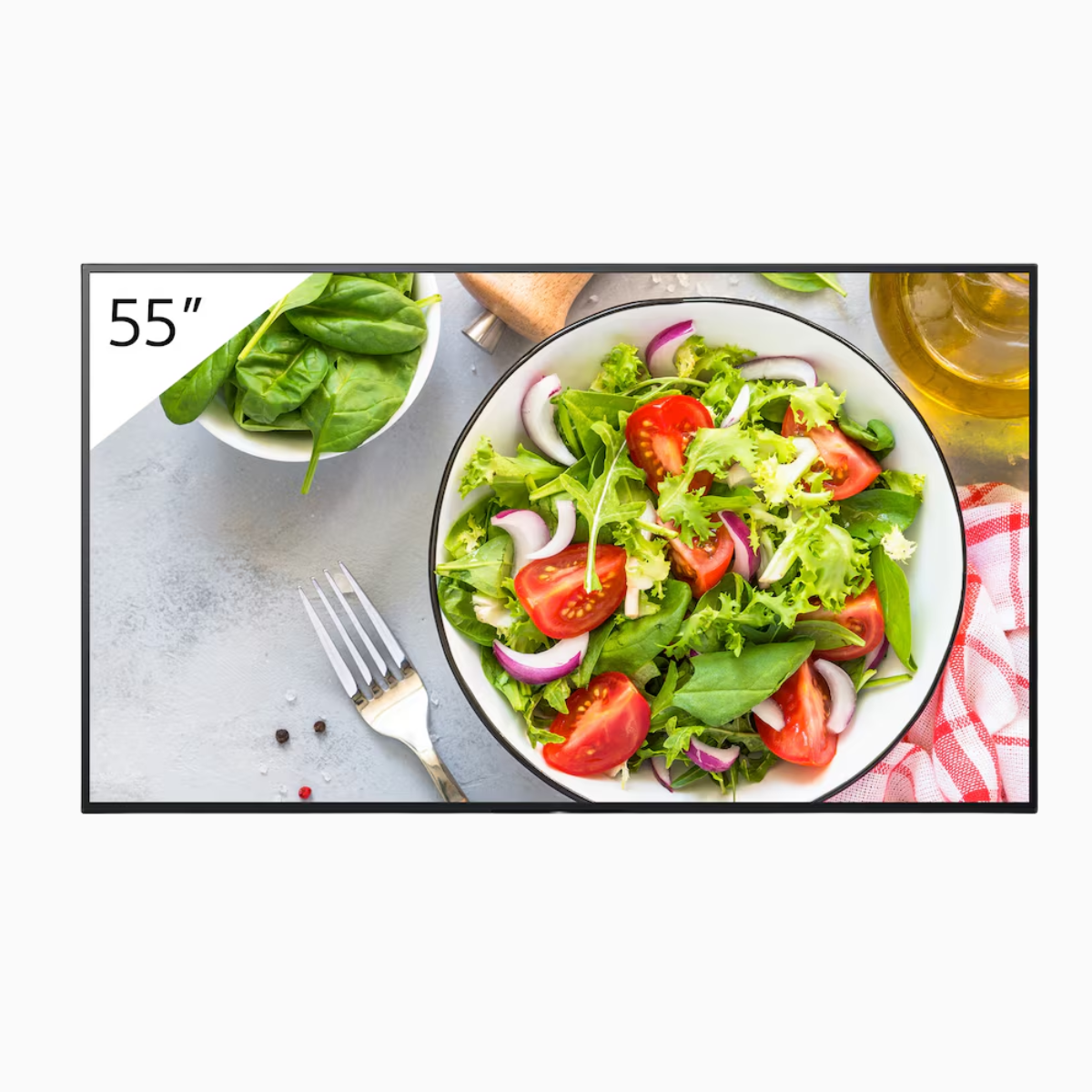 Salad on a plate with a fork and bowl of greens, displayed on a screen with '55"' text.