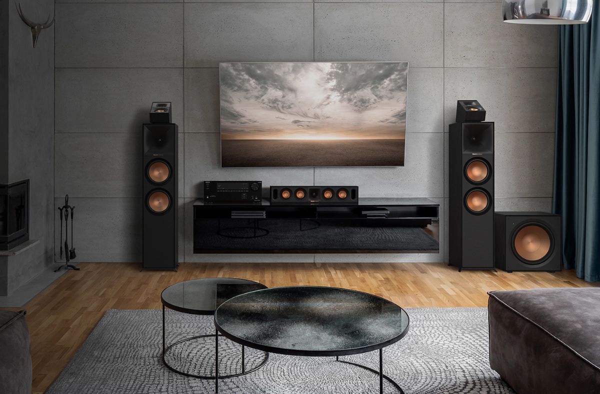 Modern living room with a television, speakers, and decorative elements.