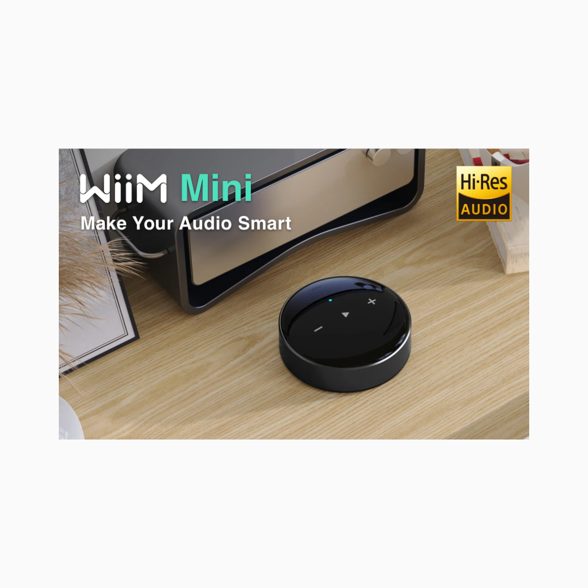 Black audio device labeled 'WiiM Mini' on a wooden surface with text 'Make Your Audio Smart' and 'Hi-Res Audio'.