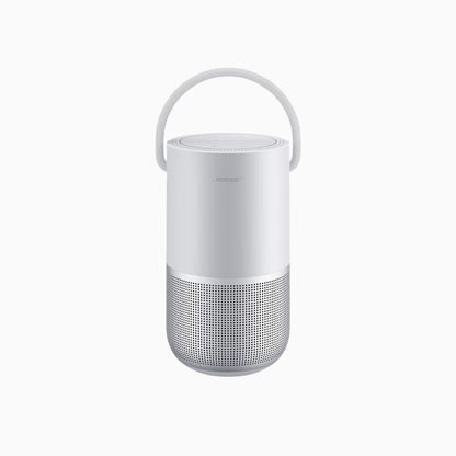 White portable speaker with a handle on a white background