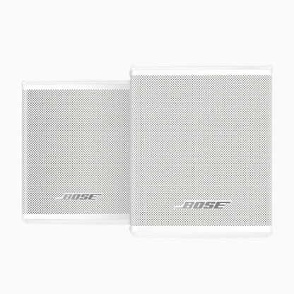 Two white Bose speakers on a white background