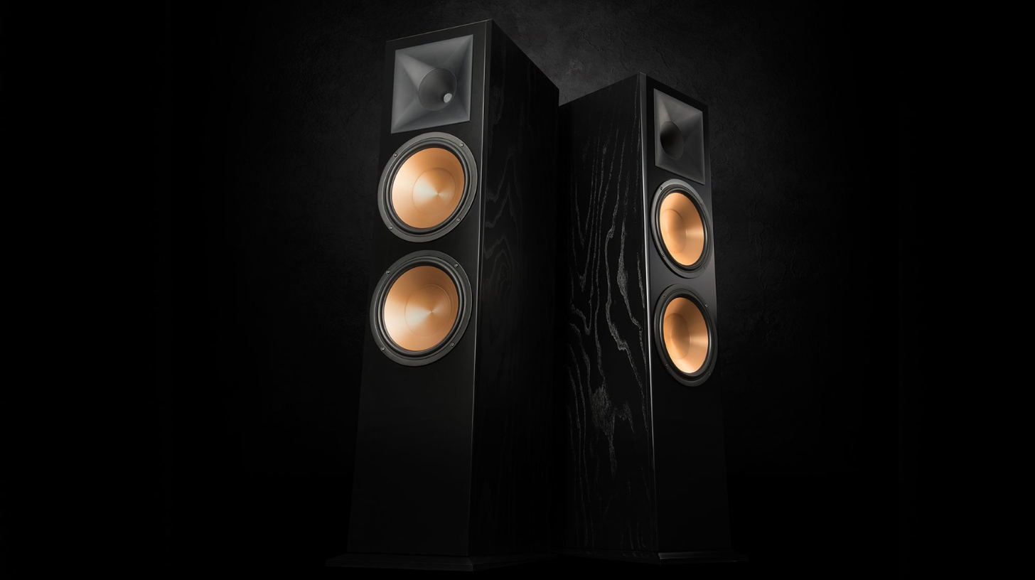 Pair of black speakers with wooden cones on a dark background