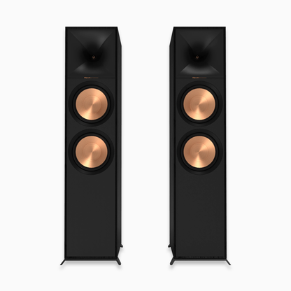 Pair of black floor-standing speakers with copper accents on a white background