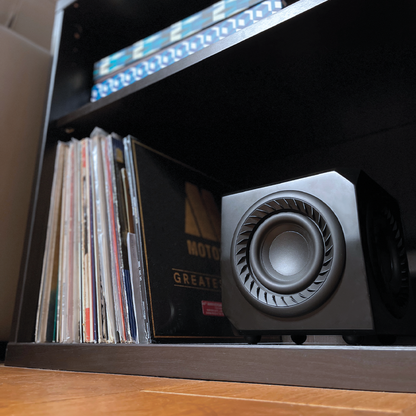Record player with vinyl records on a shelf with Subwoofer