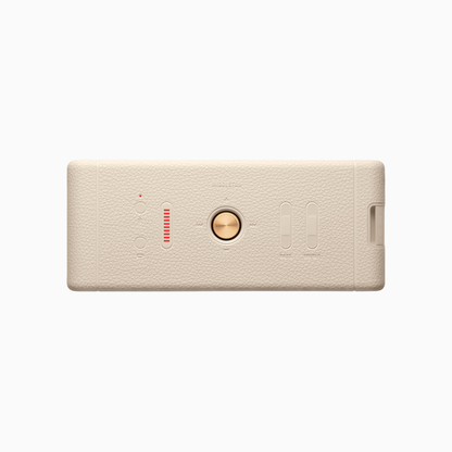 Beige electronic device with a circular button on a white background