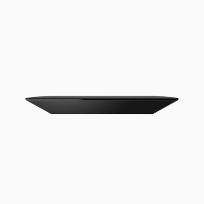 White container with a black lid on a white background