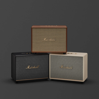 Three Marshall speakers of different colors on a dark background