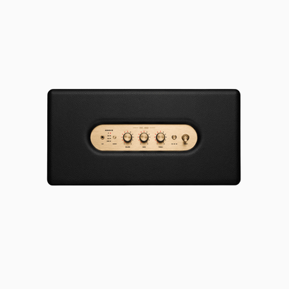 Black rectangular electronic device with gold control panel on a white background